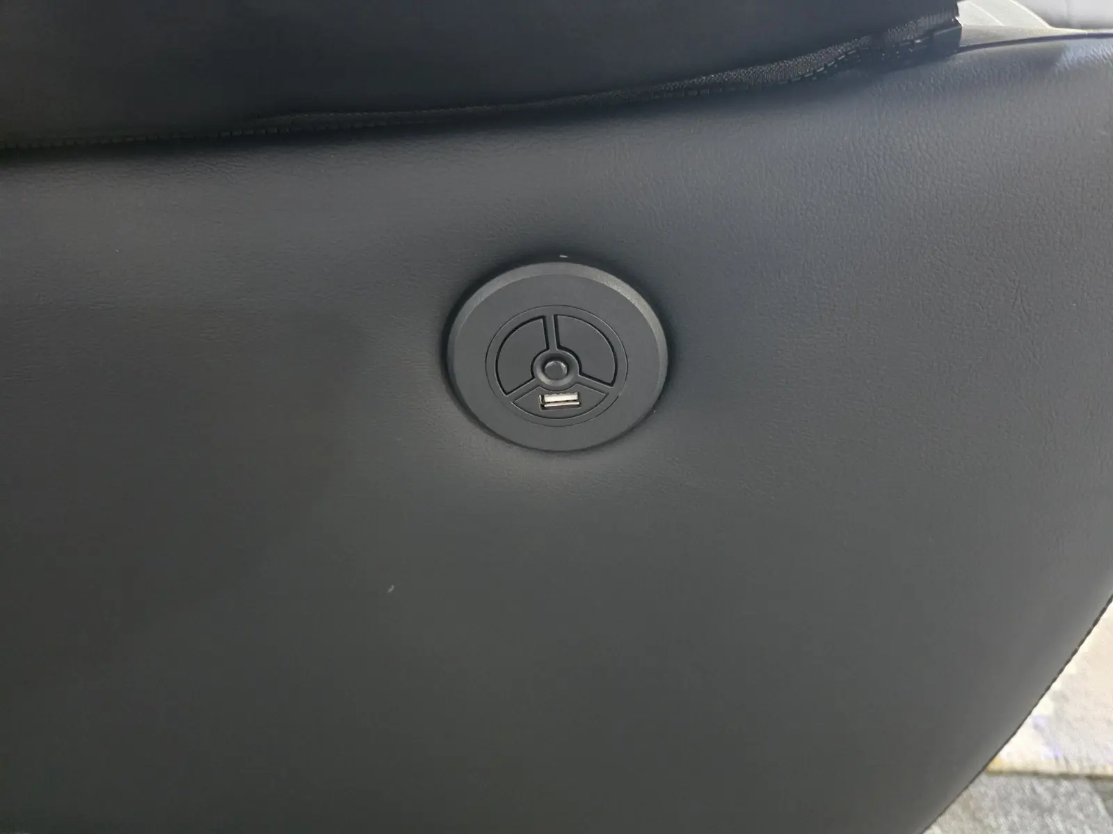 Reclining button on power recliner sofa